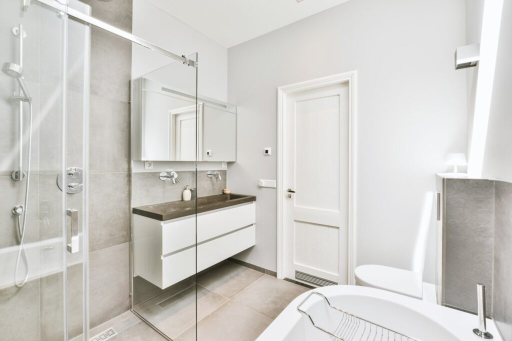 Sinks and bathtub near shower cabin